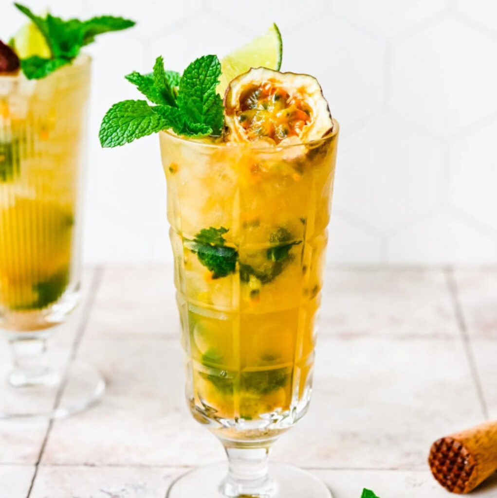 Passionfruit cocktail with mint garnish in wine glass